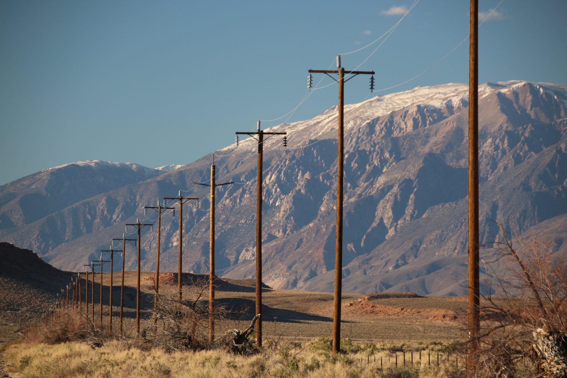 telephone wires with a mountain in the background