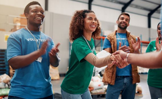 Group of people volunteering and a woman shaking hads